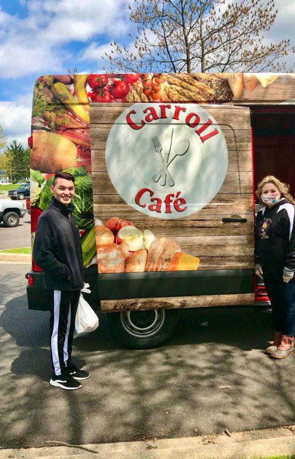 Senior, Irvin Castillo, and Mrs. Krone pose in front of the Carroll Café food truck.